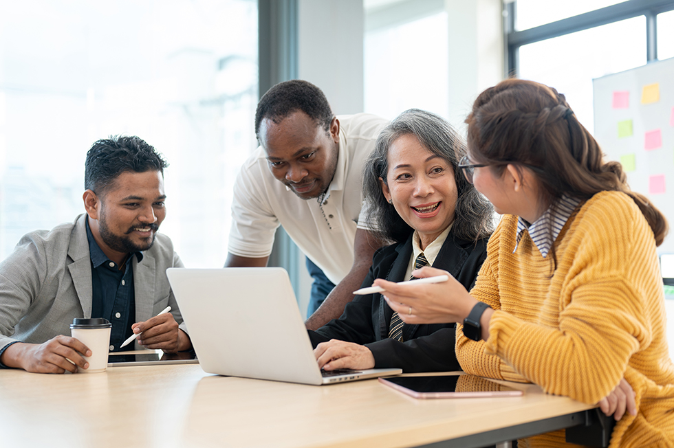 A group of diverse businesspeople or startups is discussing, planning, and brainstorming on a new project in the meeting room together. African American, Indian, Asian, Thai